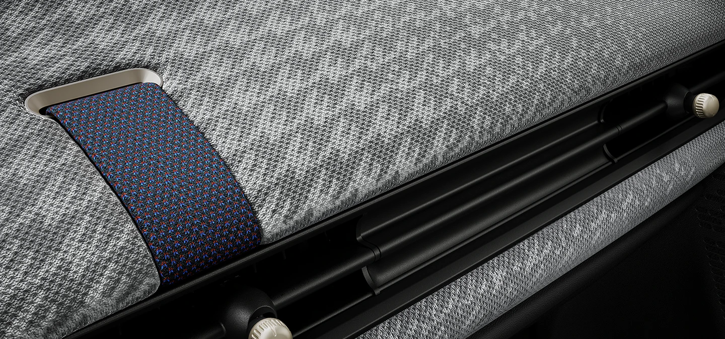 Close-up van het 2D-geweven dashboard aan de binnenkant van de MINI Cooper.