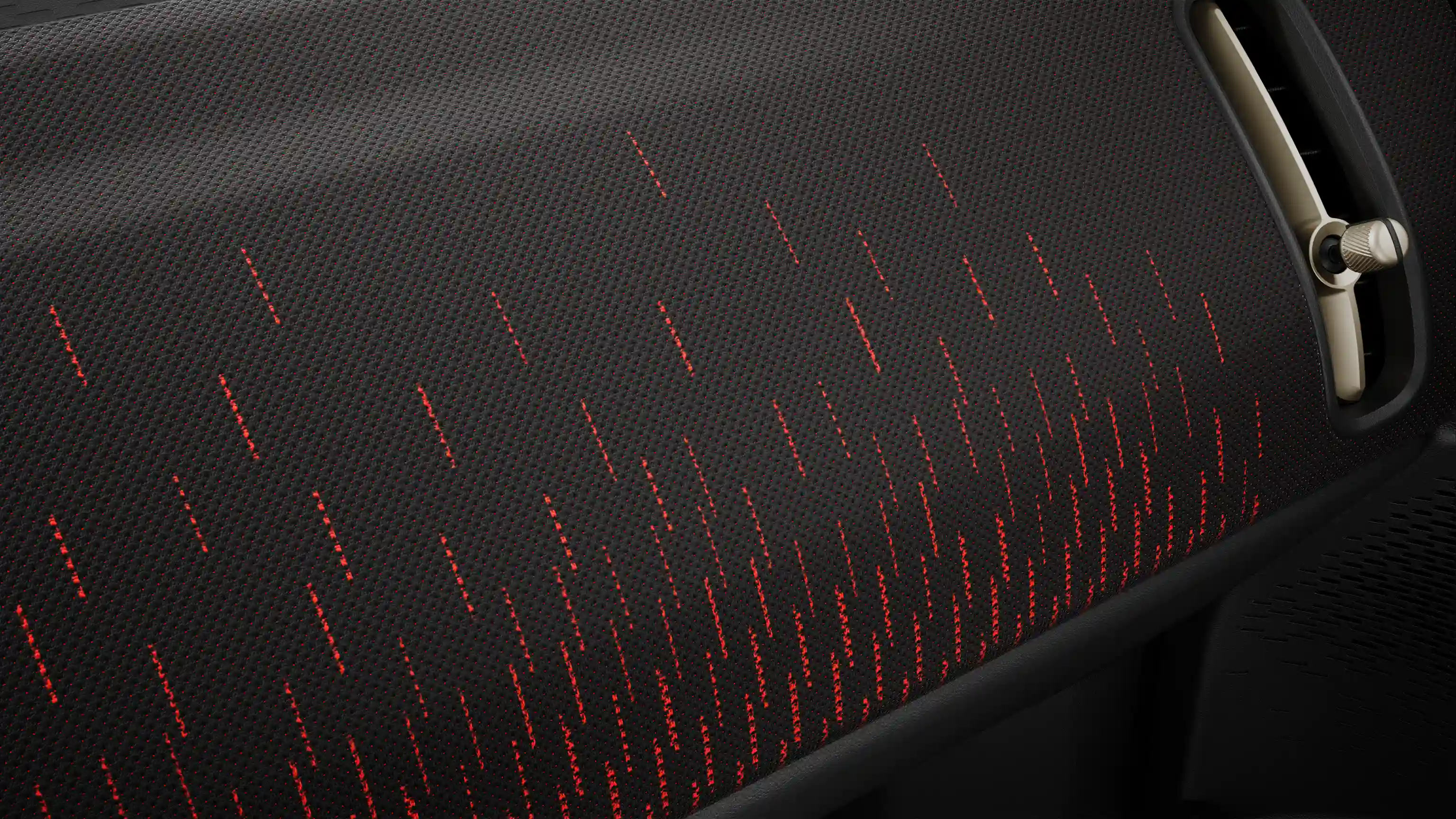 Een blik op het dashboard van de MINI Countryman Electric JCW Style in rood en zwart