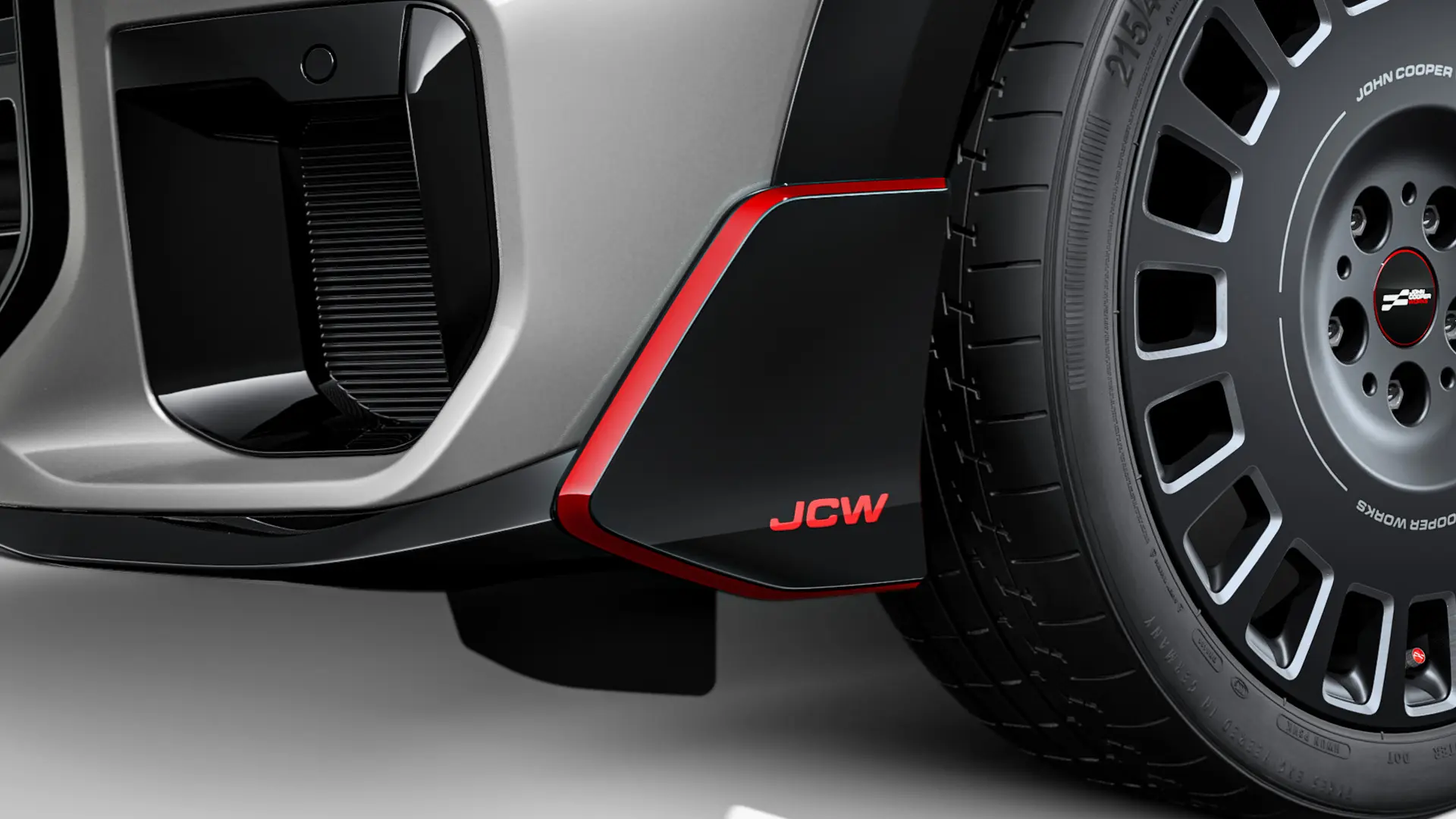Ailette avant MINI John Cooper Works en noir brillant avec lettrage JCW et bandes rouges.